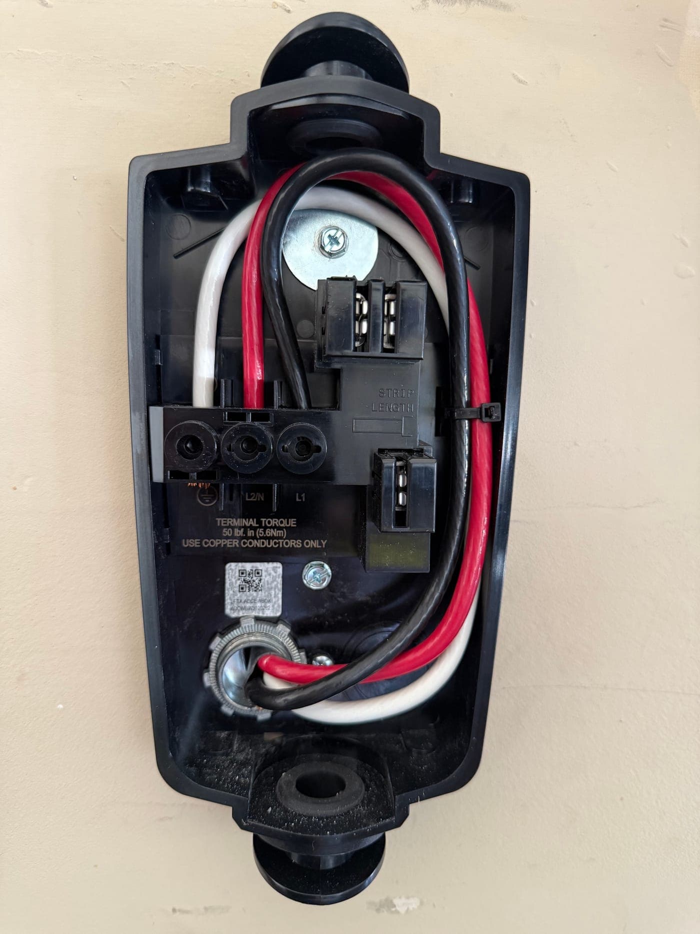 The inside of an automatic transfer switch, showing the service conductors landed on the line and load lugs.